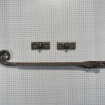 Raamuitzetter met krul, ijzer geroest.