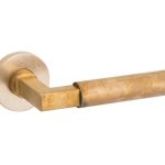 Deurklink op geveerd rozet Bauhaus/Vivo messing antiek